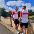 Load image into Gallery viewer, Two male cyclists chatting on a bridge in matching cycling bib shorts and cycling jerseys