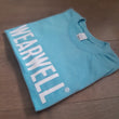 Load image into Gallery viewer, Sky team t-shirt in organic cotton folded showing front Wearwell logo