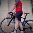 Load image into Gallery viewer, Gambler cycling collection for men with cycling shorts and red jersey next to road racing bicycle