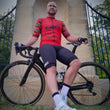 Load image into Gallery viewer, Man with road racing bicycle and wearwell gambler cycling jersey in red and cycling shorts